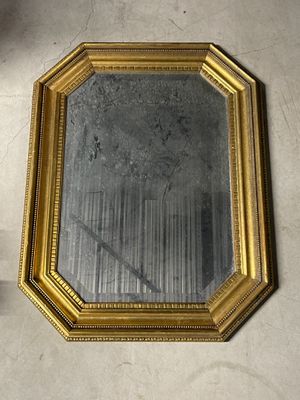 a mirror that is sitting on the floor next to a wall