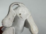 a small white elephant that is sitting in someone ' s hand