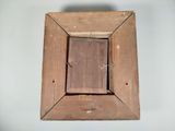 a picture of a wooden picture frame hanging on a wall