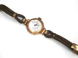 an image of a close up of a wrist watch on a white surface
