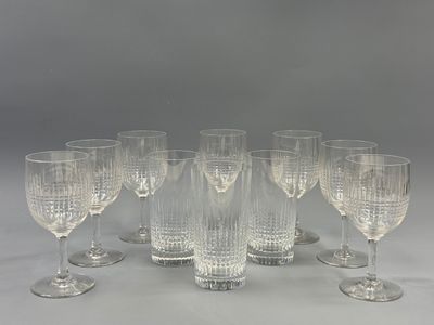 six clear wine glasses sitting on top of a table