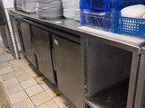many plates and bowls on the counter in the kitchen