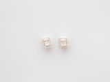 a pair of diamond earrings on a white background