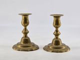 pair of antique brass candlesticks on a white background