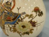a white vase with a picture of a woman and flowers on it