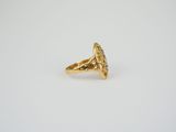 a close up of a gold ring on a white surface
