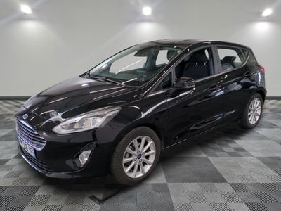 a black ford fiesta parked on a checkered floor in a garage