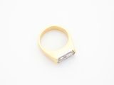a close up of a gold ring with a diamond in the middle