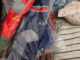 a pile of clothes sitting on top of a bed