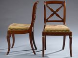 pair of mahogany dining chairs with upholstered seat cushions