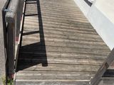 a wooden bench sitting on the side of a building