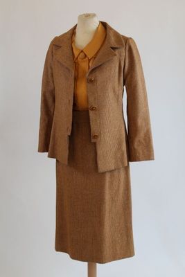 an image of a woman ' s dress and jacket on a mannequin