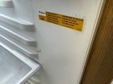 a white refrigerator with a door open in a room