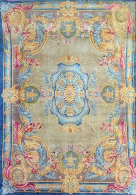 a blue and yellow rug with a floral design on it
