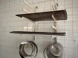 pots and pans hanging on the wall in the kitchen