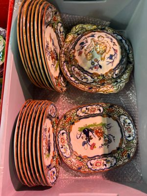 a lot of plates in a plastic container on the table
