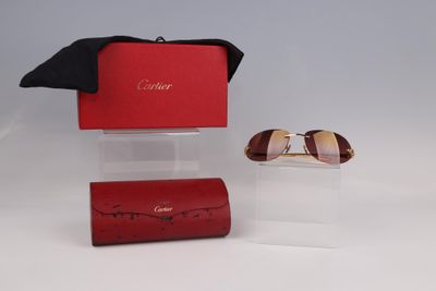 pair of sunglasses in a red case and a pair of sunglasses in a red case