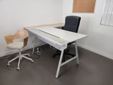 a white desk with a black chair and a brown chair
