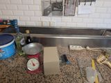 a picture of a kitchen counter with a scale and other items on it
