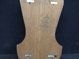 an image of a wooden guitar stand with a black background
