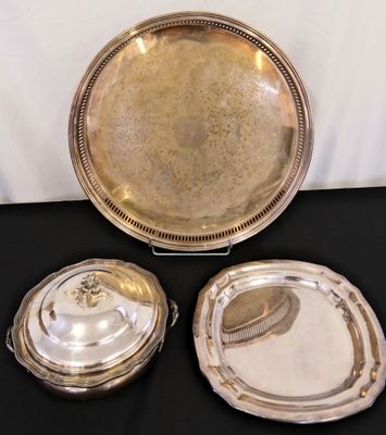 two silverplated trays with lids and lids on a black table