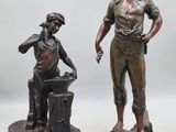 pair of bronze figurines of a boy and a boy with a bucket