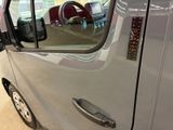 a close up of a silver truck with a red seat in the back