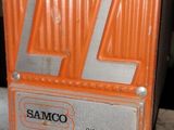a sign that says samco on it in front of a car