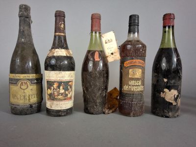 several bottles of wine are lined up on a table