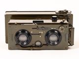 an old camera that is sitting on a white surface