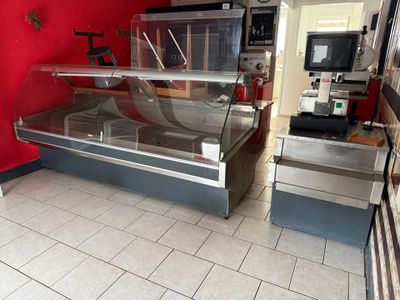 une vitrine au milieu d'une cuisine dont l'un des murs est rouge