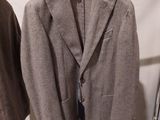 two jackets hanging on a rack in a clothing store