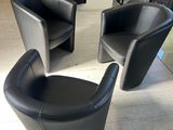 two black chairs that are sitting in a living room