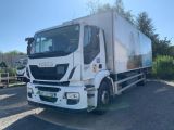 a white truck parked in a lot with other trucks in the background