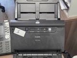 an image of a desk with a printer, telephone, and other office supplies