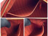 the inside of a red purse with a zipper open