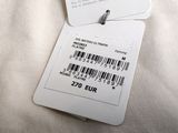 two tags attached to the back of a white shirt
