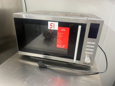 a microwave that is sitting on a table in the kitchen