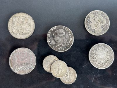 several coins are arranged on a table with a black background