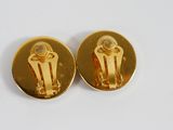 pair of gold plated earrings with a white stone in the center