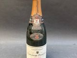 an image of a bottle of champagne sitting on a table