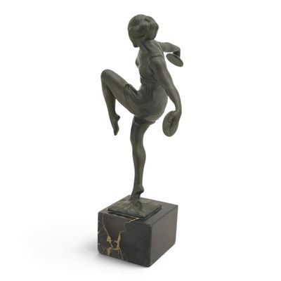 statue of a woman kicking a soccer ball on a marble base