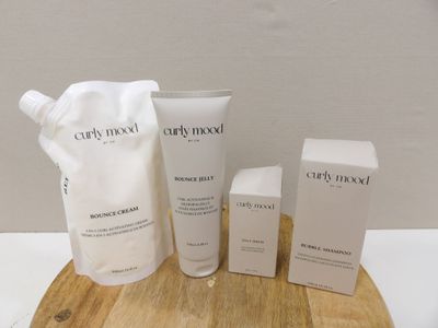 an assortment of skin care products sitting on top of a wooden board