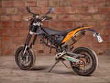 a dirt bike parked in front of a brick wall