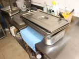 une grande casserole en métal posée sur un plan de travail de cuisine