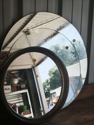 a mirror that is sitting on a wooden table