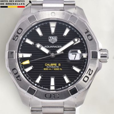 a close up of a watch on a white surface