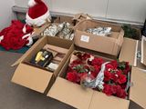 many boxes of christmas decorations and a santa hat on the floor