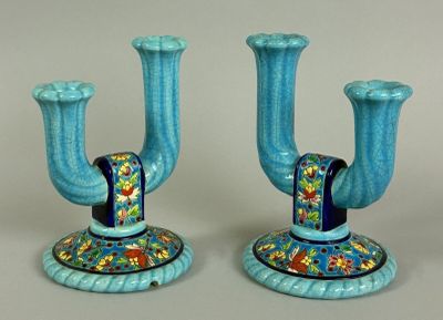 two blue candlesticks that are sitting on a table