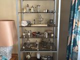 a glass shelf with various items on it in a room